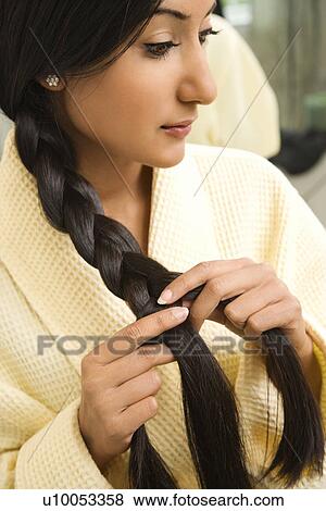 Close up profile of Asian/Indian young woman braiding hair. View Large Photo Image Stock Photo - Close up profile of Asian/Indian young woman braiding hair.. Fotosearch