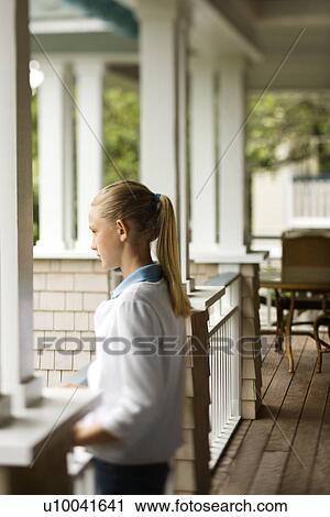 Side view of Caucasian pre-teen girl standing on porch. View Large Photo Image Stock Image - Side view of Caucasian pre-teen girl standing on porch.. Fotosearch
