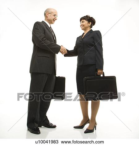 Caucasian middle-aged businessman and Filipino businesswoman standing looking at eachother shaking hands against white background. View Large Photo Image Stock Image - Caucasian middle-aged businessman and Filipino businesswoman standing looking at eachother shaking hands against white background.. Fotosearch