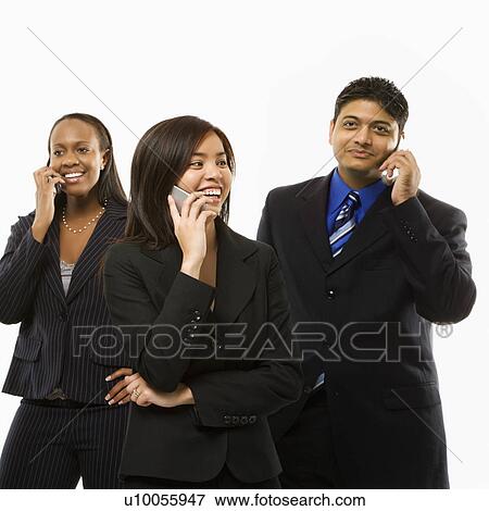 Stock Photo - Multi-ethnic businesswomen and businessman standing talking on cell phones.. Fotosearch