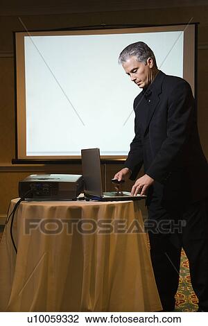 Prime adult Caucasian businessman giving presentation. View Large Photo Image Stock Image - Prime adult Caucasian businessman giving presentation.. Fotosearch