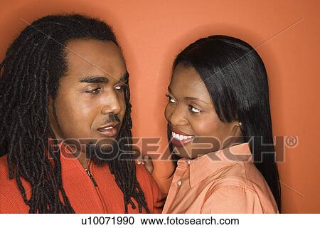 African-American mid-adult couple wearing orange clothing on orange background. View Large Photo Image Stock Image - African-American mid-adult couple wearing orange clothing on orange background.. Fotosearch