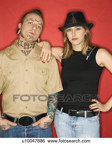 Stock Photograph - Caucasian mid-adult man and teen female standing together looking at viewer.. Fotosearch