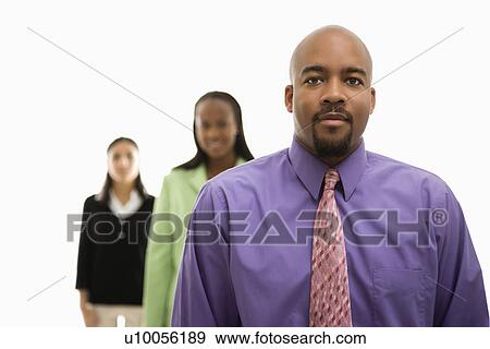 Stock Photo - African-American businessman portrait with businesswomen in background looking at viewer.. Fotosearch