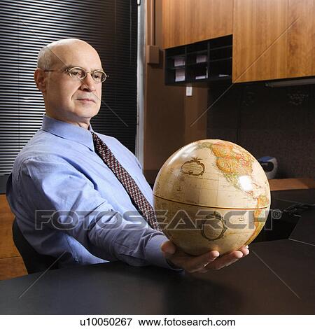 Caucasian Middle Aged Businessman Sitting At Desk In Office