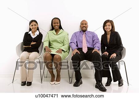 Multi-ethnic business group of men and women sitting and smiling at viewer. View Large Photo Image Stock Image - Multi-ethnic business group of men and women sitting and smiling at viewer.. Fotosearch