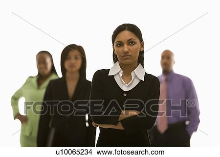 Portrait of Indian businesswoman with arms crossed with others in background. View Large Photo Image Picture - Portrait of Indian businesswoman with arms crossed with others in background.. Fotosearch