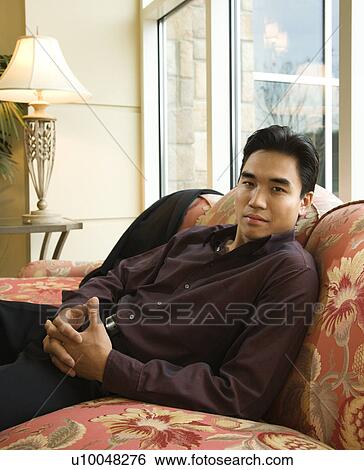 Stock Photograph - Prime adult Asian businessman in hotel.. Fotosearch