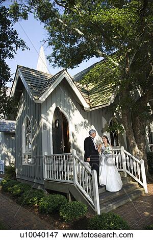 Bride and groom leaving church together. View Large Photo Image Stock Photo - Bride and groom leaving church together.. Fotosearch