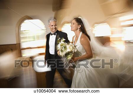 Bride and groom leaving church with motion blur effect. View Large Photo Image Picture - Bride and groom leaving church with motion blur effect.. Fotosearch