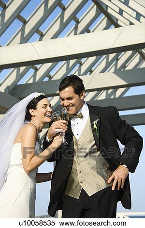 Caucasian mid-adult bride and groom drinking champagne. View Large Photo Image Stock Photography - Caucasian mid-adult bride and groom drinking champagne.. Fotosearch