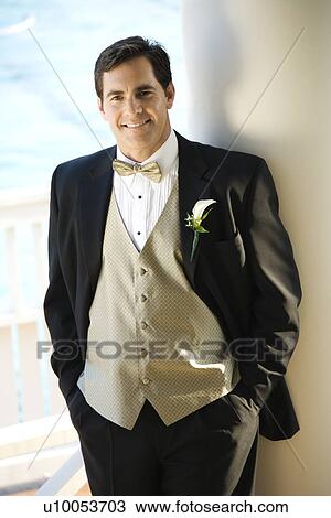 Stock Image -  Portrait of Caucasian mid-adult groom in tuxedo smiling.. Fotosearch