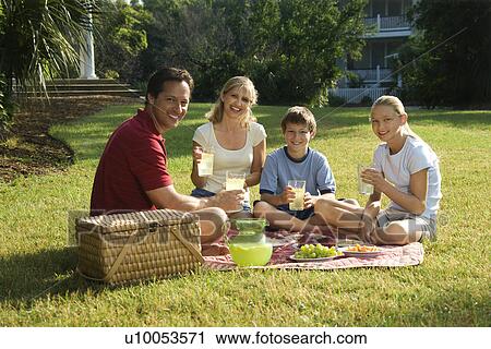 Caucasian family of four having picnic in park. View Large Photo Image Stock Image - Caucasian family of four having picnic in park.. Fotosearch