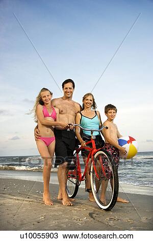 Caucasian family of four walking on beach. View Large Photo Image Stock Image - Caucasian family of four walking on beach.. Fotosearch