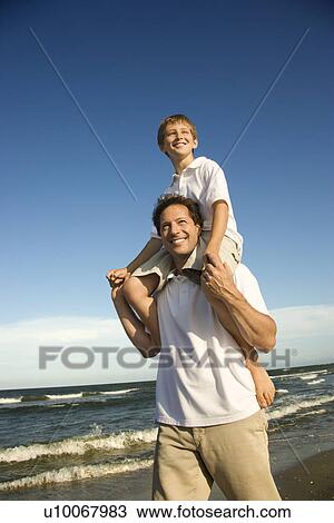 Caucasian father with pre-teen boy on shoulders on beach. View Large Photo Image Stock Image - Caucasian father with pre-teen boy on shoulders on beach.. Fotosearch