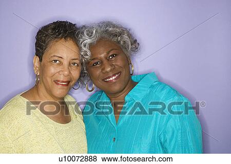 Stock Photo - Mature adult African American females looking at viewer smiling.. Fotosearch