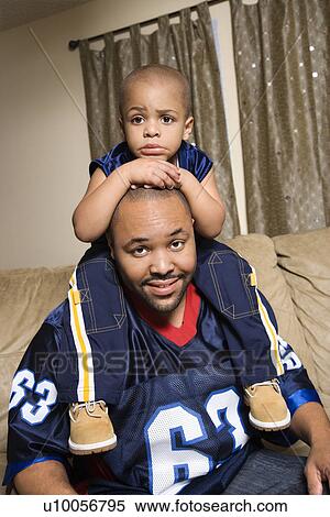 Portrait of African-American father with his son on his shoulders. View Large Photo Image Stock Photography - Portrait of African-American father with his son on his shoulders.. Fotosearch