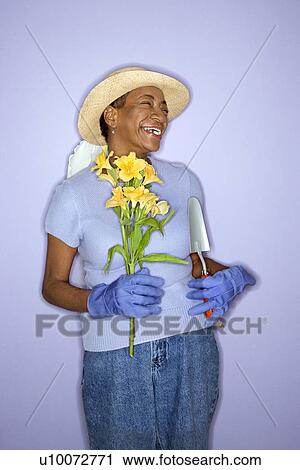African American mature adult female with hand shovel and flowers. View Large Photo Image Stock Image - African American mature adult female with hand shovel and flowers.. Fotosearch
