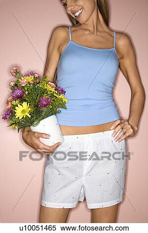Caucasian mid-adult female holding pot of flowers on hip. View Large Photo Image Stock Photography - Caucasian mid-adult female holding pot of flowers on hip.. Fotosearch