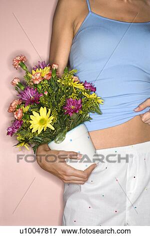 Detail of Caucasian female holding pot of flowers at hip. View Large Photo Image Stock Photo - Detail of Caucasian female holding pot of flowers at hip.. Fotosearch