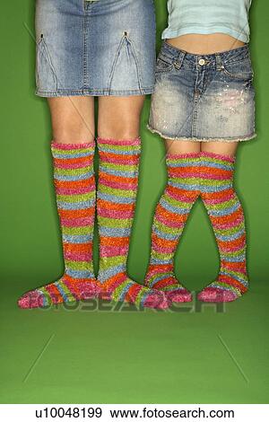 Stock Photo - Caucasian female children wearing striped socks.. Fotosearch