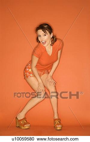 Caucasian mid-adult woman posing on orange background. View Large Photo Image Stock Image - Caucasian mid-adult woman posing on orange background.. Fotosearch