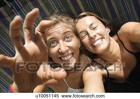 Caucasian mid-adult women being silly in hammock. View Large Photo Image Stock Photography - Caucasian mid-adult women being silly in hammock.. Fotosearch