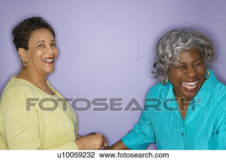 Stock Image - Mature adult African American females laughing.. Fotosearch