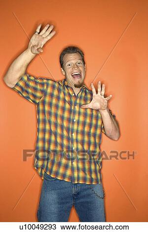 Portrait of surprised-looking adult Caucasian man on orange background. View Large Photo Image Stock Image - Portrait of surprised-looking adult Caucasian man on orange background.. Fotosearch