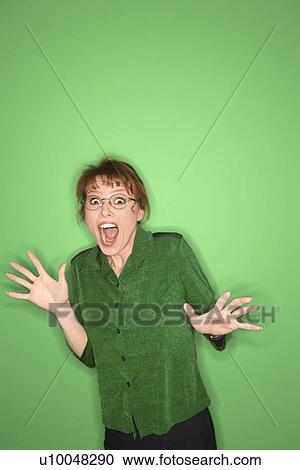 Smiling Caucasian mid-adult woman gesturing on green background. View Large Photo Image Stock Image - Smiling Caucasian mid-adult woman gesturing on green background.. Fotosearch