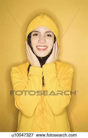 Smiling young Caucasian woman wearing yellow raincoat on yellow background. View Large Photo Image Stock Photo - Smiling young Caucasian woman wearing yellow raincoat on yellow background.. Fotosearch