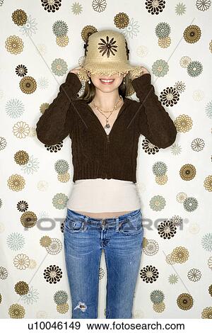 Caucasian adolescent female pulling hat over eyes. View Large Photo Image Stock Photo - Caucasian adolescent female pulling hat over eyes.. Fotosearch