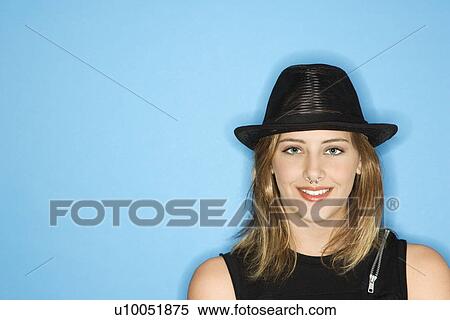 Stock Photography - Caucasian young adult female wearing hat smiling.. Fotosearch