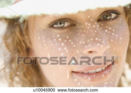 Close-up of young adult female Caucasian with shadow pattern from straw hat on face. View Large Photo Image Stock Image - Close-up of young adult female Caucasian with shadow pattern from straw hat on face.. Fotosearch