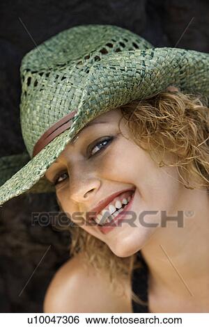 Stock Photograph - Close up portrait of young adult female Caucasian in hat.. Fotosearch
