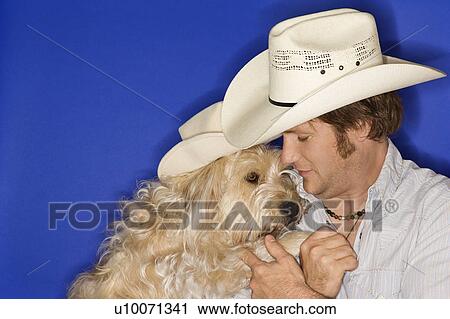 Fluffy brown dog and male Caucasian young adult wearing cowboy hats. View Large Photo Image Stock Image - Fluffy brown dog and male Caucasian young adult wearing cowboy hats.. Fotosearch
