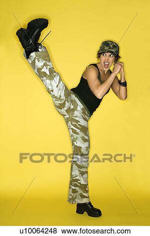 Hispanic mid-adult woman kicking. View Large Photo Image Stock Photo - Hispanic mid-adult woman kicking.. Fotosearch