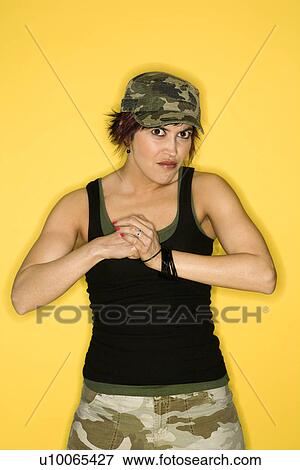 Stock Photo - Hispanic mid-adult woman making fist.. Fotosearch