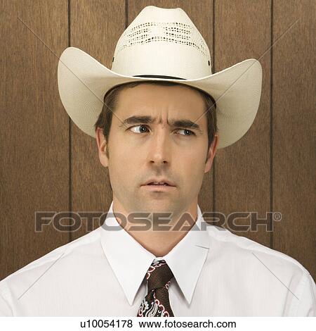 Mid-adult Caucasian male wearing a cowboy hat lookinig off to side. View Large Photo Image Stock Photo - Mid-adult Caucasian male wearing a cowboy hat lookinig off to side.. Fotosearch
