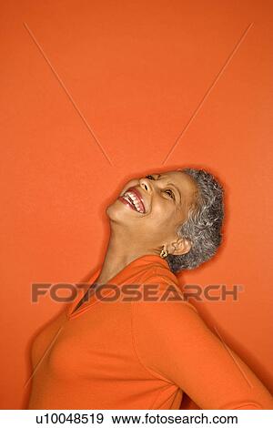 Stock Photo - African American mature adult female with head back smiling.. Fotosearch