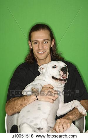 Caucasian mid-adult man holding white Pit Bull on lap. View Large Photo Image Stock Photo - Caucasian mid-adult man holding white Pit Bull on lap.. Fotosearch