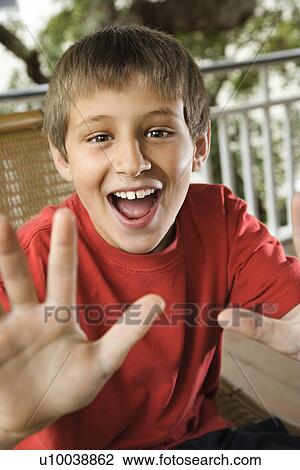 Caucasian teenage boy looking happy and excited reaching hand out. View Large Photo Image Stock Image - Caucasian teenage boy looking happy and excited reaching hand out.. Fotosearch