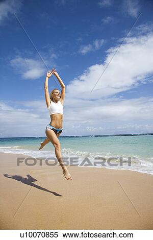 Caucasian young adult woman jumping on beach. View Large Photo Image Stock Photography - Caucasian young adult woman jumping on beach.. Fotosearch
