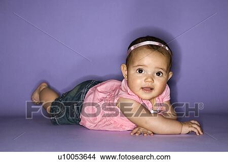 Hispanic female baby lying on stomach. View Large Photo Image Picture - Hispanic female baby lying on stomach.. Fotosearch