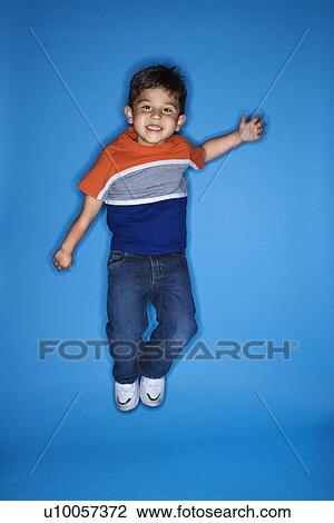 Male Hispanic boy jumping. View Large Photo Image Stock Image - Male Hispanic boy jumping.. Fotosearch
