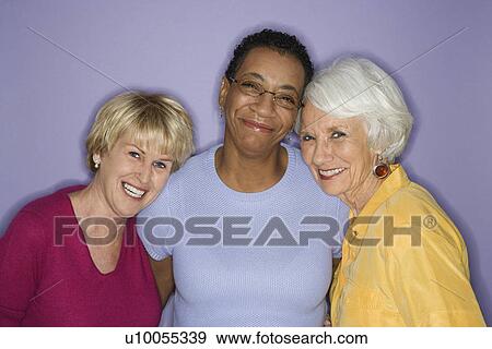 Stock Photo - Portrait of Caucasian and African American mature adult females.. Fotosearch