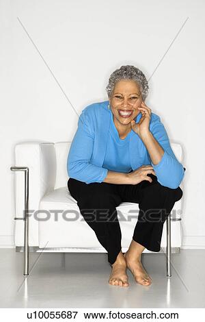 African American mature adult female sitting on chair. View Large Photo Image Stock Photo - African American mature adult female sitting on chair.. Fotosearch