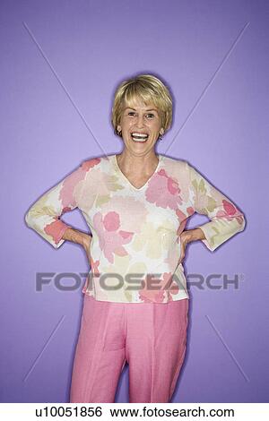 Stock Photograph - Caucasian mature adult female standing and smiling.. Fotosearch