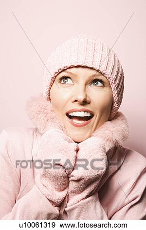 Caucasian mid-adult woman on pink background wearing winter coat and hat. View Large Photo Image Stock Photo - Caucasian mid-adult woman on pink background wearing winter coat and hat.. Fotosearch
