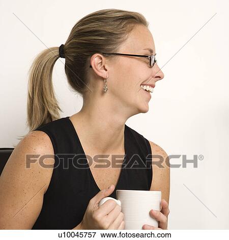 Caucasian mid-adult woman wearing eyeglasses holding coffee cup and looking to side. View Large Photo Image Stock Photo - Caucasian mid-adult woman wearing eyeglasses holding coffee cup and looking to side.. Fotosearch